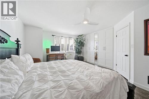Bedroom featuring a ceiling fan and dark wood-style flooring - 136 Braemar Avenue, Caledonia, ON - Indoor Photo Showing Bedroom