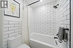 Full bathroom with shower / tub combo and toilet - 
