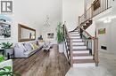 Living area featuring high vaulted ceiling, a chandelier, and stairway - 136 Braemar Avenue, Caledonia, ON  - Indoor Photo Showing Other Room 