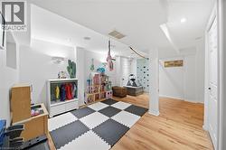 Workout room featuring light wood-type flooring and recessed lighting - 