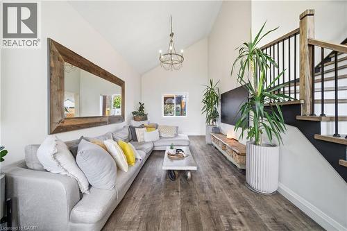 Living room with high vaulted ceiling, a chandelier, and dark wood-type flooring - 136 Braemar Avenue, Caledonia, ON - Indoor Photo Showing Living Room