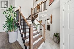 Staircase featuring washer / dryer and a towering ceiling - 