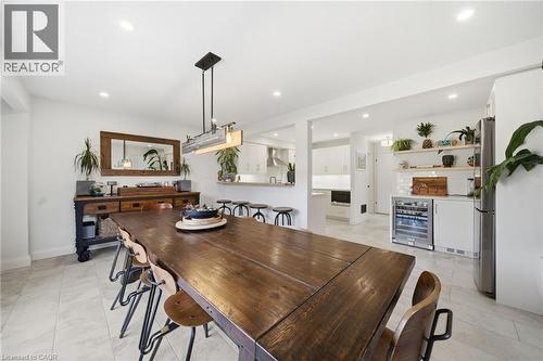 Dining area with beverage cooler, recessed lighting, a dry bar, and light tile patterned floors - 136 Braemar Avenue, Caledonia, ON - Indoor Photo Showing Dining Room