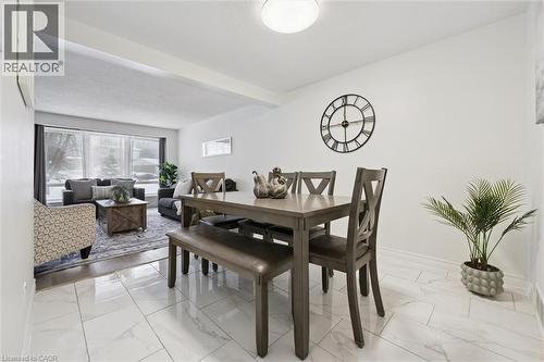 Dining area with light marble finish floors and beamed ceiling - 11 Ingleside Drive, Kitchener, ON - Indoor Photo Showing Dining Room