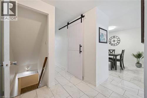 Corridor with an upstairs landing, a barn door, and light marble finish floors - 11 Ingleside Drive, Kitchener, ON - Indoor Photo Showing Other Room