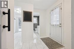 Entrance foyer featuring plenty of natural light and light marble finish flooring - 