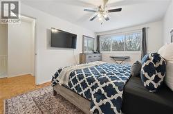 Bedroom featuring a ceiling fan and an AC wall unit - 