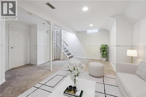 Virtually Staged Carpeted family room featuring stairs and recessed lighting - 11 Ingleside Drive, Kitchener, ON - Indoor