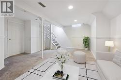 Virtually Staged Carpeted family room featuring stairs and recessed lighting - 