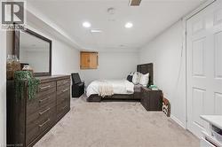Bedroom with light carpet and recessed lighting - 