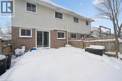 Snow covered rear of property with brick siding - 