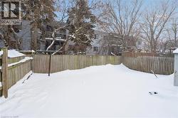 Snowy yard featuring a fenced backyard - 