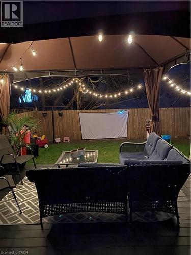 Deck at night with outdoor lounge area, a fenced backyard, and a patio - 11 Ingleside Drive, Kitchener, ON - Indoor Photo Showing Other Room