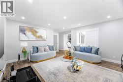Living room featuring recessed lighting, baseboards, and wood finished floors - 