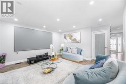 Living room featuring baseboards, recessed lighting, and wood finished floors - 