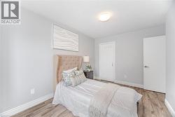 Bedroom with baseboards, a textured ceiling, and wood finished floors - 