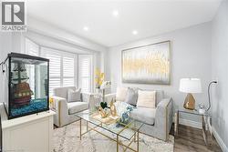 Living area featuring baseboards, recessed lighting, wood finished floors, and a textured ceiling - 