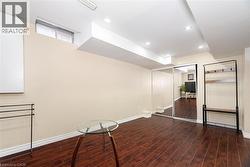 Finished below grade area with recessed lighting, baseboards, and wood finished floors - 