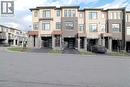 View of property with driveway, a residential view, and a garage - 155 Equestrian Way Unit# 114, Cambridge, ON  - Outdoor With Facade 