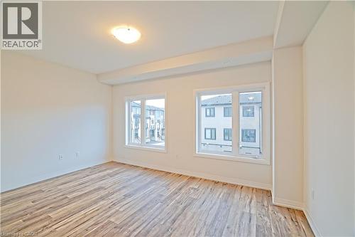 Empty room featuring light wood-style flooring - 155 Equestrian Way Unit# 114, Cambridge, ON - Indoor Photo Showing Other Room
