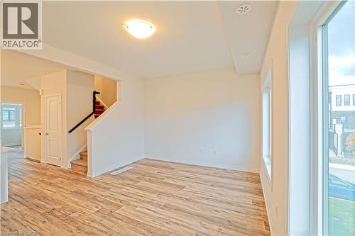 Spare room featuring light wood-type flooring and stairs - 155 Equestrian Way Unit# 114, Cambridge, ON - Indoor Photo Showing Other Room