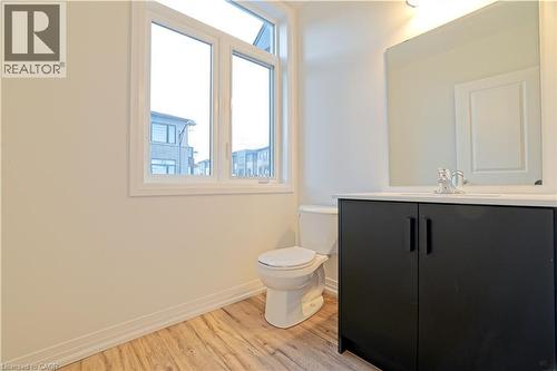 Bathroom featuring healthy amount of natural light, vanity, and light wood-type flooring - 155 Equestrian Way Unit# 114, Cambridge, ON - Indoor Photo Showing Bathroom