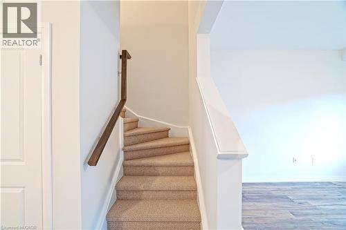Staircase with wood finished floors and baseboards - 155 Equestrian Way Unit# 114, Cambridge, ON - Indoor Photo Showing Other Room