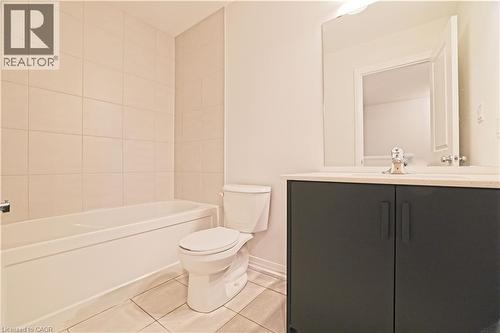 Bathroom with light tile patterned floors, vanity, and shower / tub combination - 155 Equestrian Way Unit# 114, Cambridge, ON - Indoor Photo Showing Bathroom