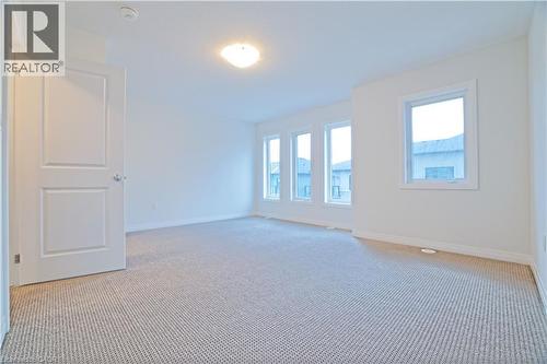 Unfurnished room with carpet floors and baseboards - 155 Equestrian Way Unit# 114, Cambridge, ON - Indoor Photo Showing Other Room