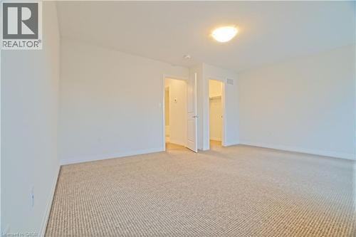 Unfurnished room featuring light colored carpet and baseboards - 155 Equestrian Way Unit# 114, Cambridge, ON - Indoor Photo Showing Other Room
