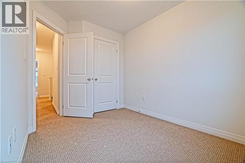 Unfurnished bedroom featuring carpet floors and a closet - 155 Equestrian Way Unit# 114, Cambridge, ON - Indoor Photo Showing Other Room