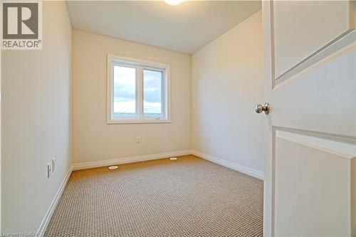 Unfurnished room with carpet floors and baseboards - 155 Equestrian Way Unit# 114, Cambridge, ON - Indoor Photo Showing Other Room