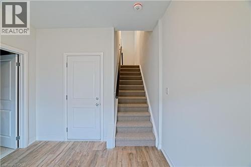 Stairs with wood finished floors and baseboards - 155 Equestrian Way Unit# 114, Cambridge, ON - Indoor Photo Showing Other Room