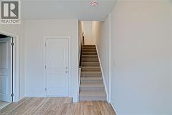 Stairs with wood finished floors and baseboards - 