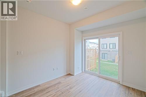 Unfurnished room featuring light wood-style flooring and baseboards - 155 Equestrian Way Unit# 114, Cambridge, ON - Indoor Photo Showing Other Room