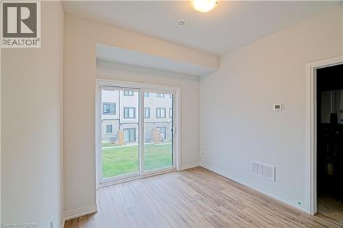 Unfurnished room featuring light wood-type flooring - 155 Equestrian Way Unit# 114, Cambridge, ON - Indoor Photo Showing Other Room