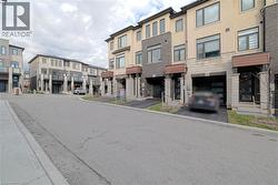 View of asphalt street featuring curbs and a residential view - 