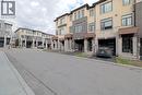 View of asphalt street featuring curbs and a residential view - 155 Equestrian Way Unit# 114, Cambridge, ON  - Outdoor With Facade 