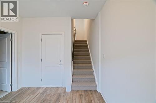 Stairway featuring wood finished floors and baseboards - 155 Equestrian Way Unit# 114, Cambridge, ON - Indoor Photo Showing Other Room
