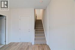 Stairway featuring wood finished floors and baseboards - 