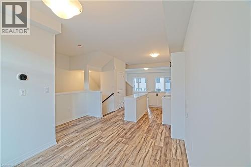 Empty room with light wood-style floors and baseboards - 155 Equestrian Way Unit# 114, Cambridge, ON - Indoor Photo Showing Other Room