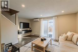 Living room leading to a fenced yard and concrete patio - 