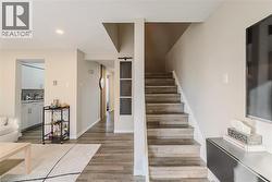 Stairs featuring wood finished floors and baseboards - 