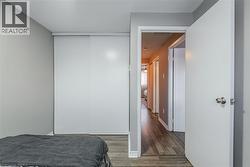 Bedroom with wood finished floors and a closet - 