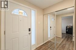 Foyer featuring wood finished floors and baseboards - 