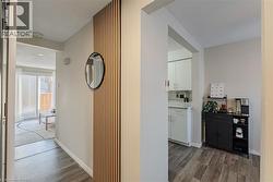 Hallway featuring dark wood-style flooring and a textured ceiling - 