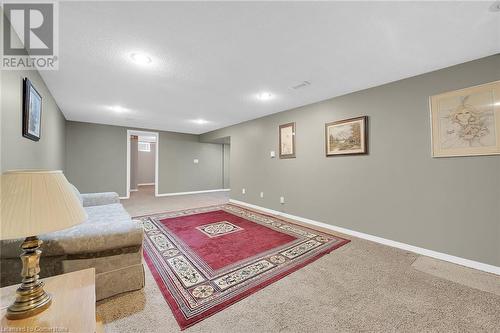 Living room featuring a textured ceiling, baseboards, carpet, and recessed lighting - 9 Gavin Drive, St. Catharines, ON - Indoor