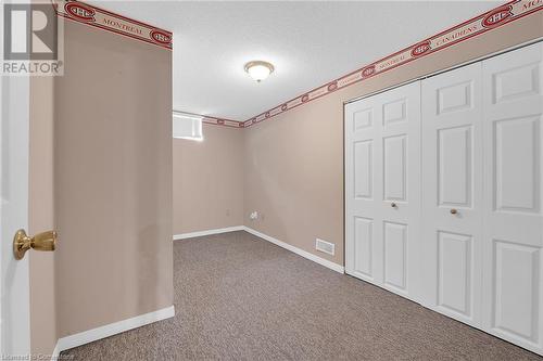 Unfurnished bedroom with carpet, a closet, baseboards, and a textured ceiling - 9 Gavin Drive, St. Catharines, ON - Indoor Photo Showing Other Room