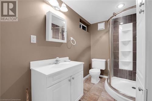 Bathroom with a shower stall, vanity, tile patterned flooring, toilet, and baseboards - 9 Gavin Drive, St. Catharines, ON - Indoor Photo Showing Bathroom