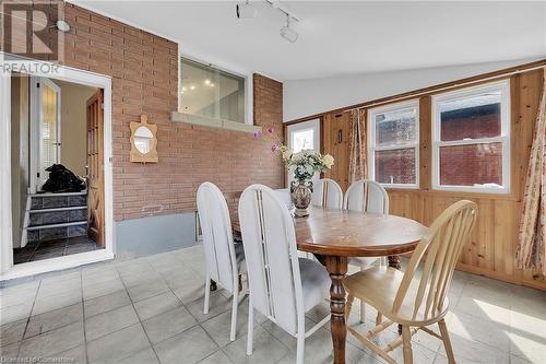 Dining room featuring track lighting, brick wall, and lofted ceiling - 9 Gavin Drive, St. Catharines, ON - Indoor Photo Showing Dining Room